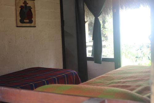 a bedroom with a bed and a window at Lodge France Amazonia in Puerto Misahuallí