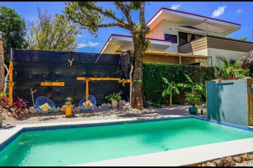a swimming pool in front of a house at Matambú Main House in Cuajiniquil
