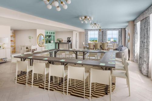 a dining room with a long table and chairs at The Goodtime Hotel, Miami Beach a Tribute Portfolio Hotel in Miami Beach