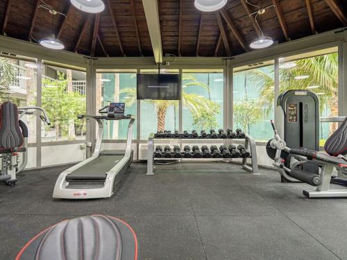 a gym with treadmills and machines in a room at Chilling 1BR Home in Orlando Next to Disney in Vineland