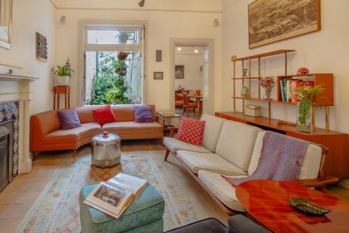 a living room with a couch and a fireplace at Casa Chapulín-Mexican Eclectic Home in Roma Norte in Mexico City