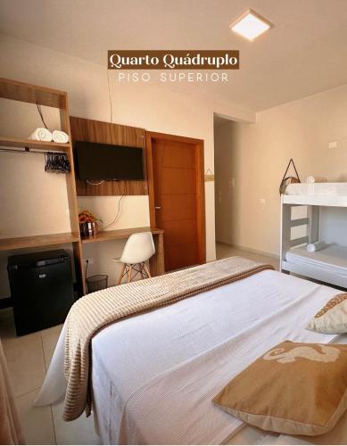 a bedroom with a large bed in a room at Pousada Villa Vantino in Penha