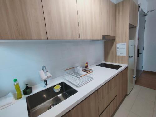 a kitchen with a sink and a counter top at Village Vibes at Splashmania Gamuda Cove in Pulau Kempas