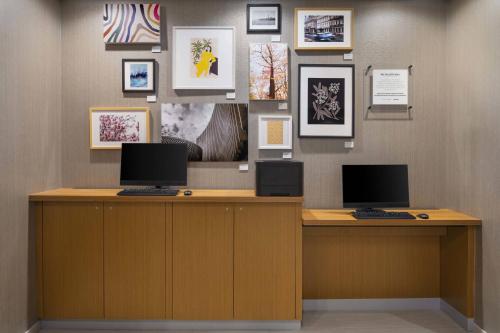 a desk with two computers on top of it at SpringHill Suites by Marriott Tuckahoe Westchester County in Tuckahoe