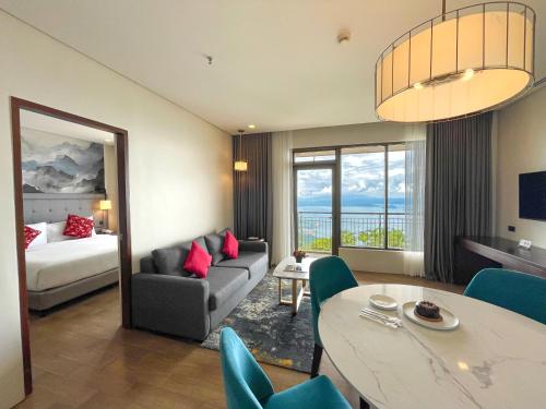 a living room with a couch and a bed and a table at Summit Ridge Tagaytay - Newly Renovated in Tagaytay