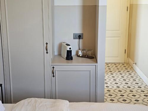 a room with a table with a toaster on it at כוהנ'ס Cohen's Boutique Hotel in Haifa