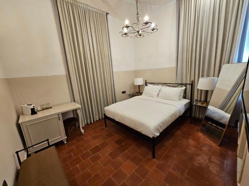 a bedroom with a bed and a chandelier at כוהנ'ס Cohen's Boutique Hotel in Haifa