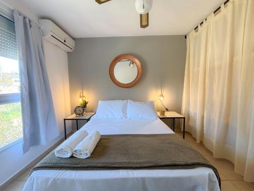 a bedroom with a bed with two towels on it at Las Martinas Piriapolis in Piriápolis