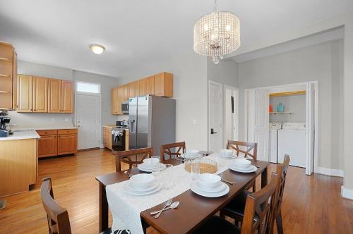 a kitchen and dining room with a table and chairs at Spacious 3-Bedroom with King Bed & Prime Location in Tower Grove
