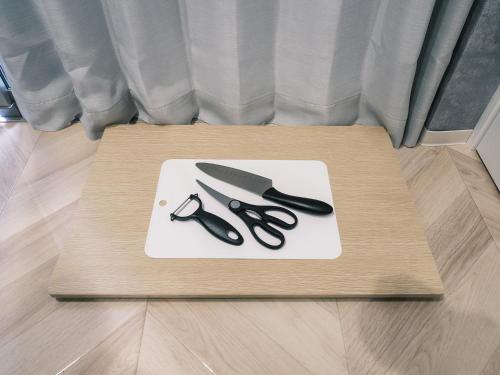 a pair of scissors on a cutting board on a table at Tsubame INN Nipponbashi in Osaka