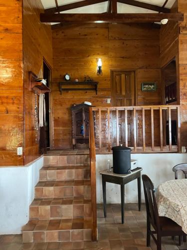 a room with a staircase with a table and a stove at PROVENZA en Los Naranjos in Juayúa