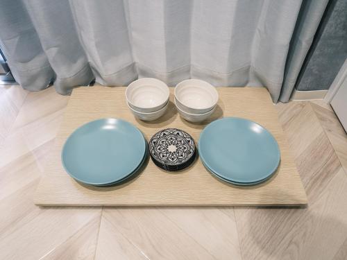 three plates and bowls on a wooden tray at Tsubame INN Nipponbashi in Osaka