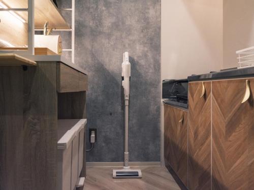 a kitchen with a candle on the floor in a room at Tsubame INN Nipponbashi in Osaka