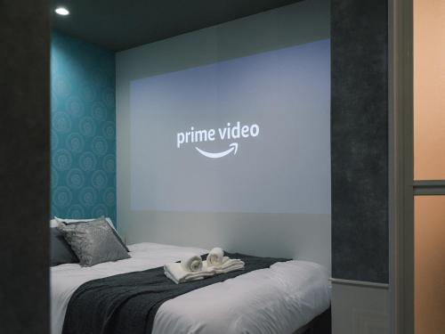 a room with two beds and a sign for prime video at Tsubame INN Nipponbashi in Osaka