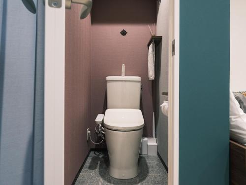 a bathroom with a toilet in a small room at Tsubame INN Nipponbashi in Osaka