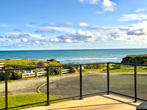 a view of the ocean from a balcony at Luxury Absolute Ocean View Lodge in Waverley
