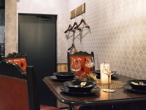 a table with black plates and a candle on it at Tsubame INN Nipponbashi in Osaka