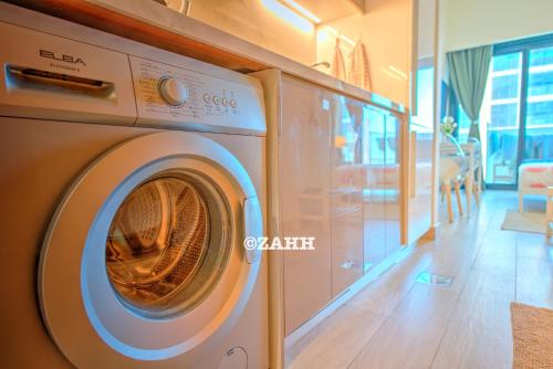 a washing machine is sitting in a room at Studio Haven in Dubai