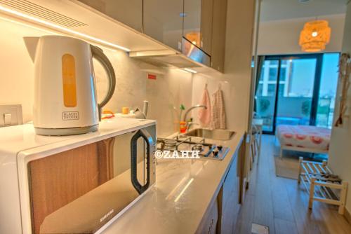 a kitchen with a toaster sitting on top of a microwave at Studio Haven in Dubai