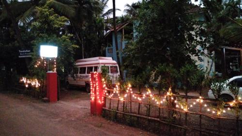 a van parked next to a fence with christmas lights at Tendulkar Beach Resort in Diveagar