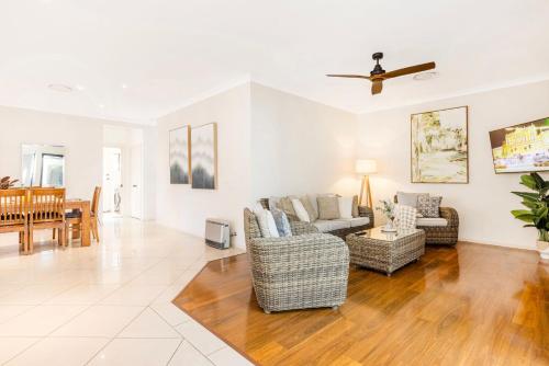 a living room with a couch and chairs at The Atrium by Experience Jervis Bay in St Georges Basin