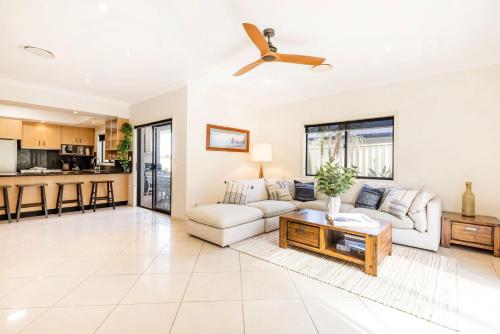 a living room with a couch and a table at The Atrium by Experience Jervis Bay in St Georges Basin