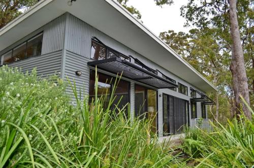 a house with a large window on the side of it at Aranakie- 7 Grey Street South West Rocks NSW 2431 in Arakoon