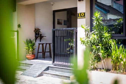 a front door of a house with plants at Hoi An Clara House in Hoi An