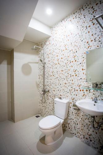 a bathroom with a toilet and a sink at Hoi An Clara House in Hoi An