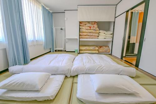 Postel nebo postele na pokoji v ubytování ゲストハウスあさひ