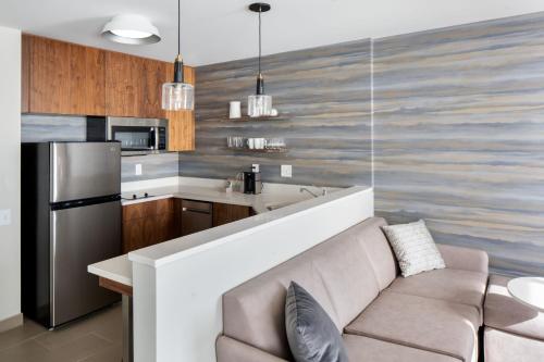 a living room with a couch and a kitchen at Residence Inn by Marriott Tampa Wesley Chapel in Wesley Chapel