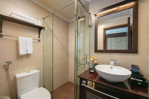 a bathroom with a toilet and a sink and a shower at Mila Cruises in Ha Long