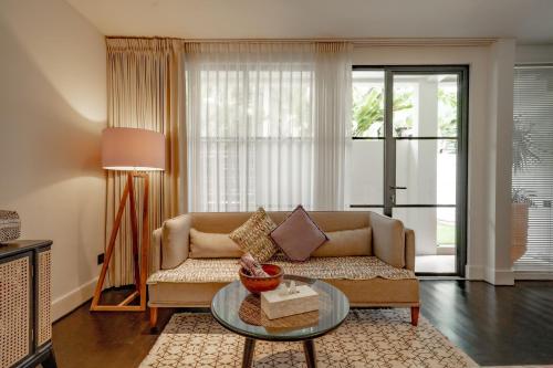 a living room with a couch and a table at Martini Suite and Villa in Kerobokan