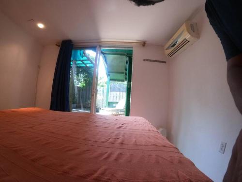 a bedroom with a large bed with a window at Island Relax Retreat in Willemstad