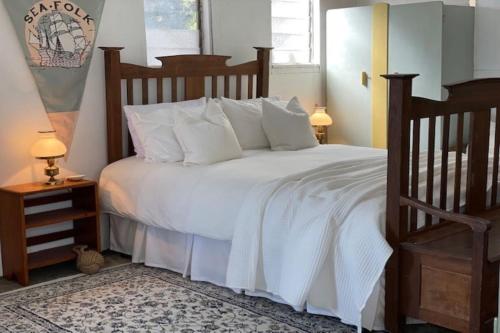 a bedroom with a large bed with white sheets and pillows at Boathouse - Highest Hilltop On Oceanfront in Lancelin