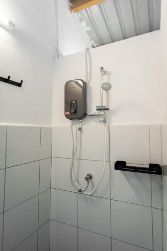a shower in a bathroom with a soap dispenser on the wall at The Terraces by Aayu - 2 mins walk to Chulia Street in George Town