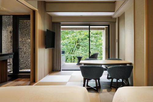 a dining room with a table and chairs at Laforet Shuzenji Sanshisuimei in Izu