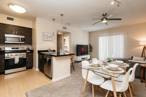 a kitchen and living room with a table and chairs at Luxury One Bedroom minutes from The Grove in Los Angeles