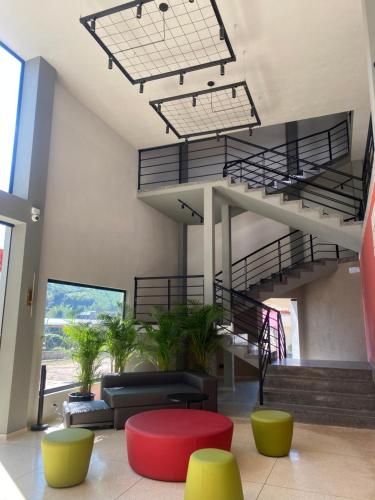 a lobby with stairs and a couch and a table at Hotel La Vega in Concepción