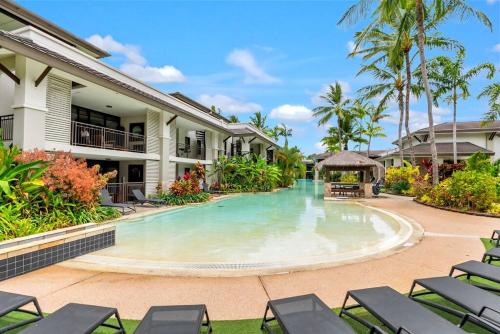 a swimming pool in the middle of a resort at Luxury Port Douglas beachside 3 Bedroom Temple Apartment with Private roof top terrace Due to copyright we can't disclose the resort name but google Port Douglas temple and this fantastic 5 star resort will come up in Port Douglas