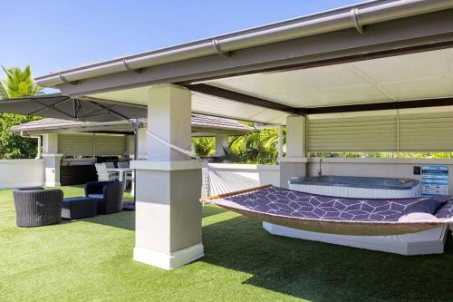 a hammock under a pergola in a backyard at Luxury Port Douglas beachside 3 Bedroom Temple Apartment with Private roof top terrace Due to copyright we can't disclose the resort name but google Port Douglas temple and this fantastic 5 star resort will come up in Port Douglas