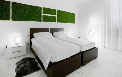 a bedroom with a large bed with a green painting on the wall at villa centro Greve in Chianti in Greve in Chianti