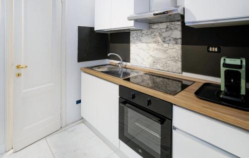 a kitchen with white cabinets and a sink and a stove at villa centro Greve in Chianti in Greve in Chianti