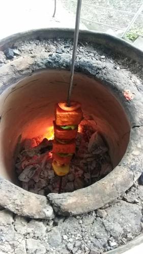 a stack of food is cooking in a pot at Experto The Greens in Nainital