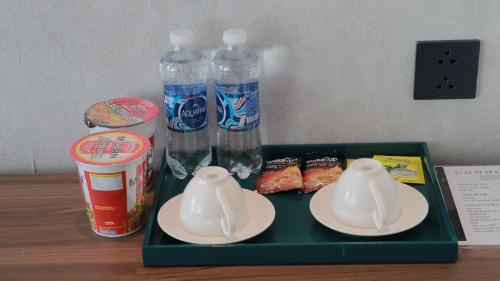 a tray with two plastic bottles of water on a table at Apec Boutique Hotel Phú Yên in Tuy Hoa