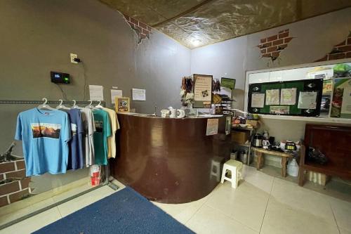 a shop with a counter with shirts hanging on the wall at Viewscape Nature Park Tanay powered by Cocotel in Tanay