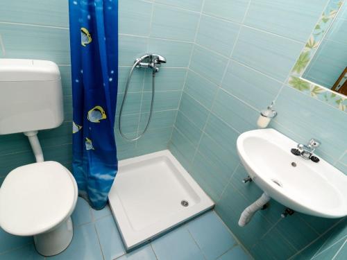 a bathroom with a toilet and a sink at Apartment with balcony and sea view in Pomena