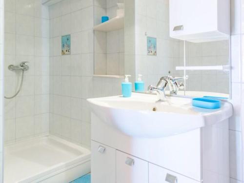 a white bathroom with a sink and a shower at Apartment Magdalena - Three Bedroom Apartment in Nerežišća