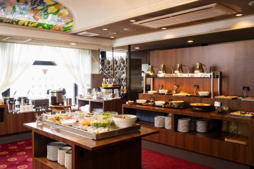 a restaurant with a buffet of food on display at Hotel Arthur KITAHAMA BASE in Beppu