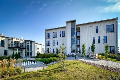 an apartment building with a park in front of it at Hanko Holiday Apartment in Hanko
